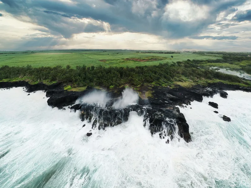 Big waves breaking on the black cliffs of the south coast, Mauritius