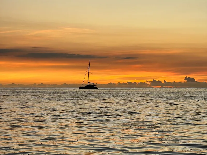 Sailboat at sunset off Grand Baie